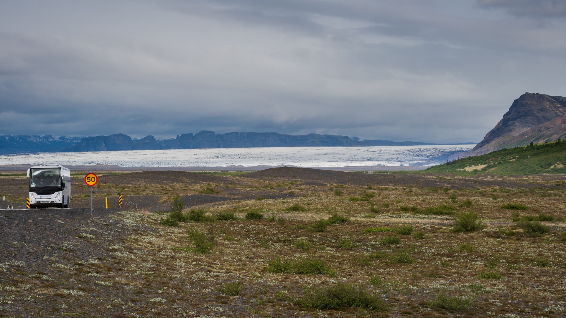 Arctic Adventures tour bus on the road.